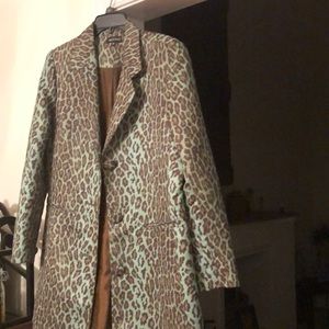 Single breasted leopard colored pant coat .